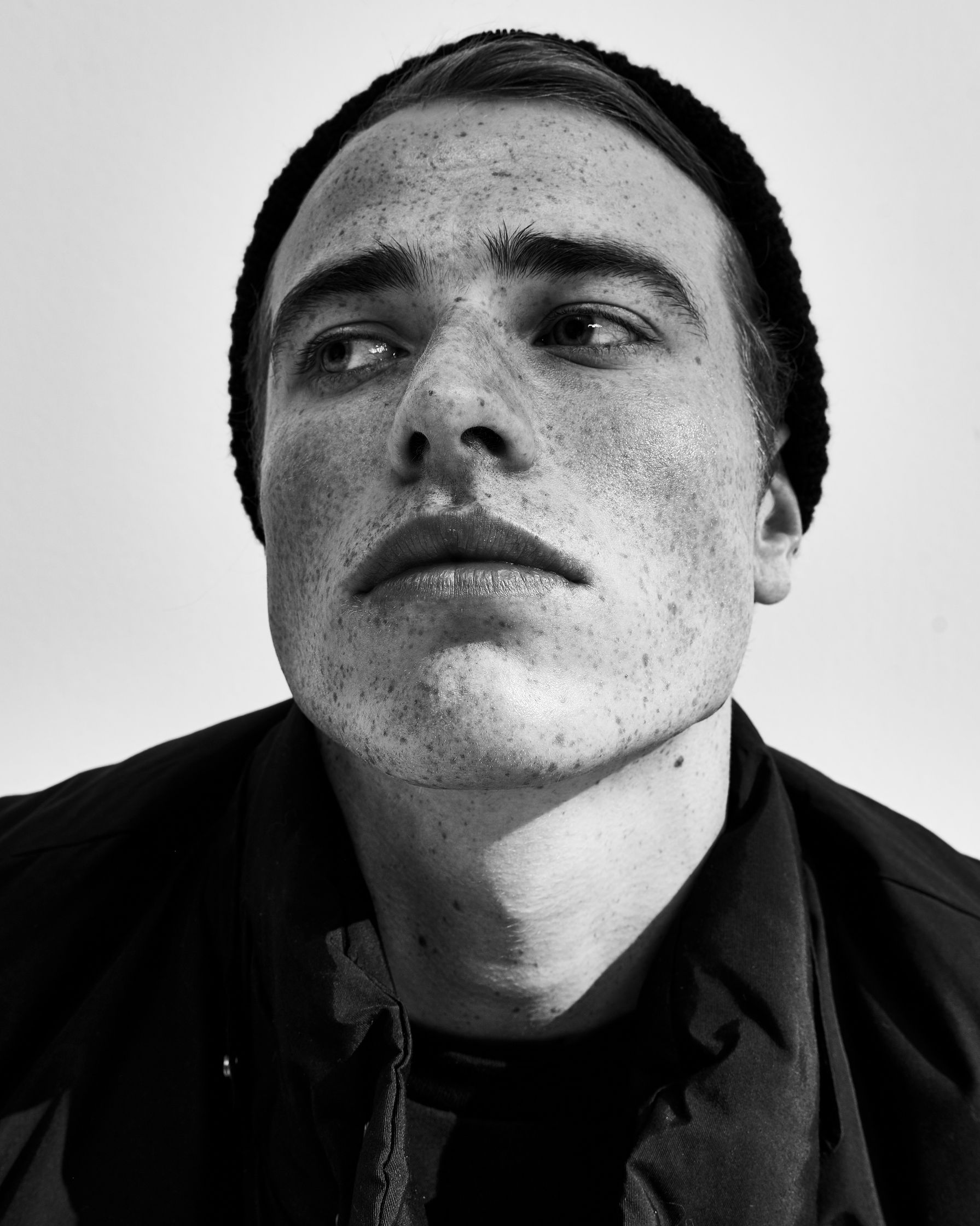 a black and white photo of a man with freckles by Martin Kula, photographer
