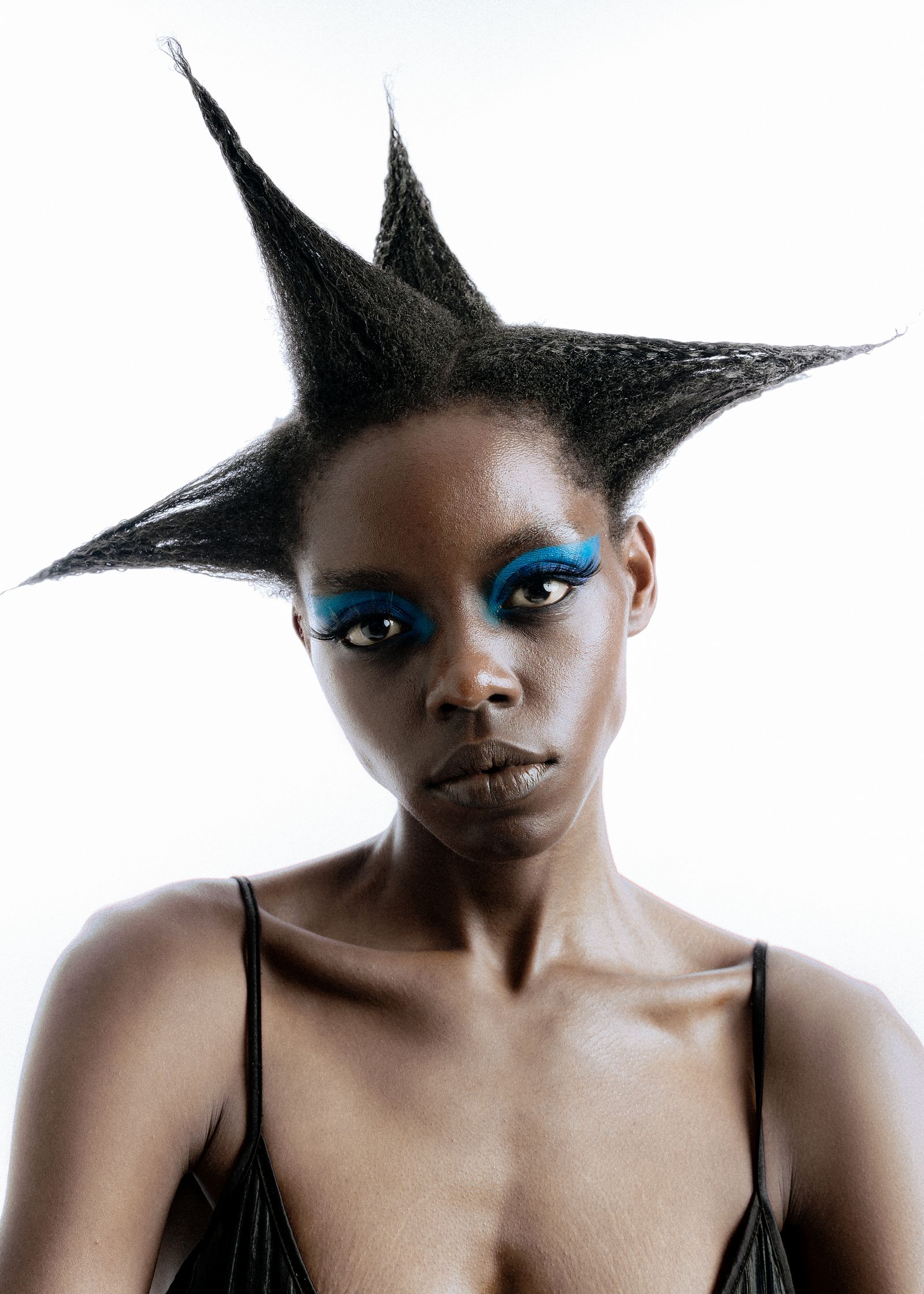 a black woman with an afro hairstyle and blue eyes shot by faith adu afriyie