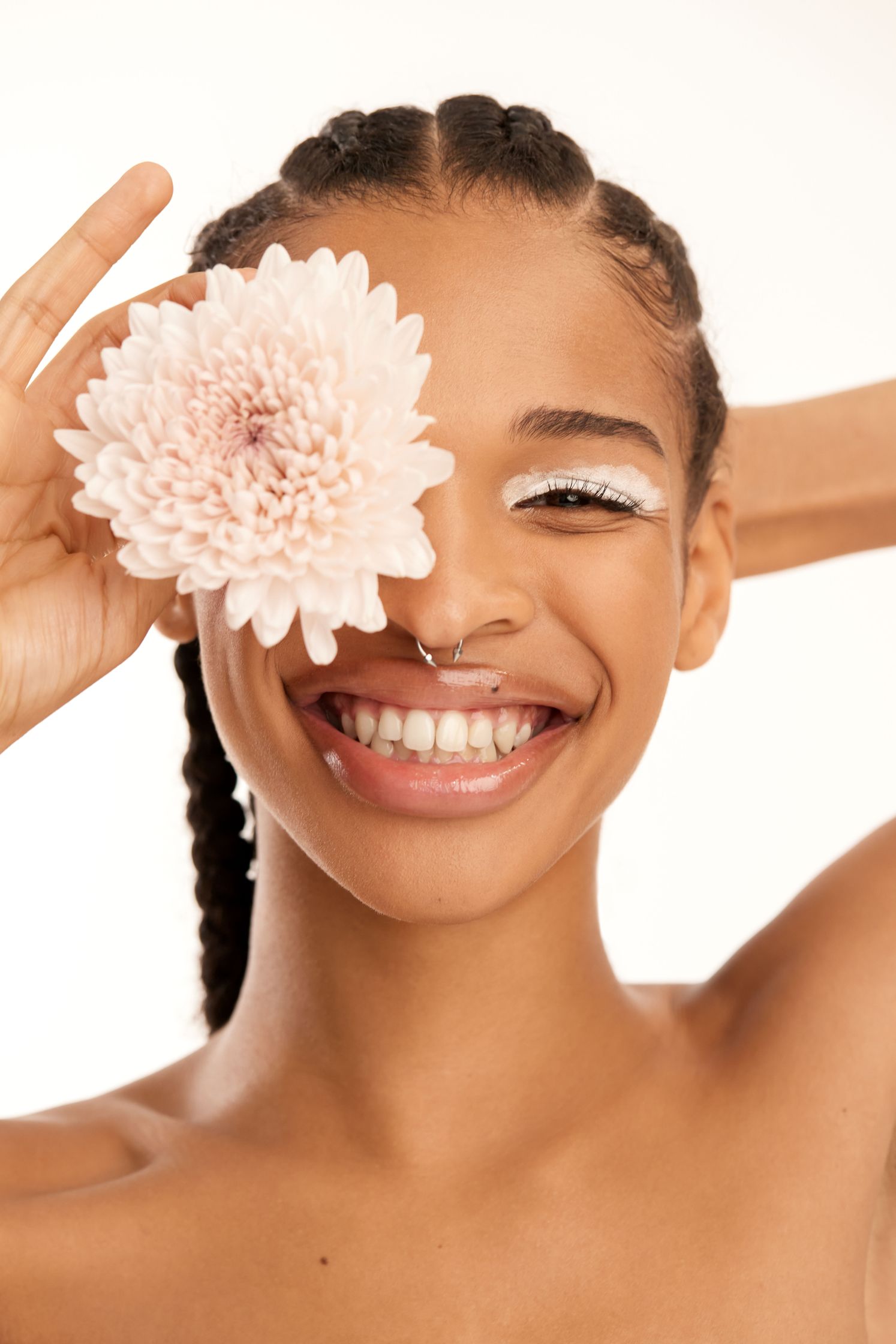 a black woman with a flower on her face