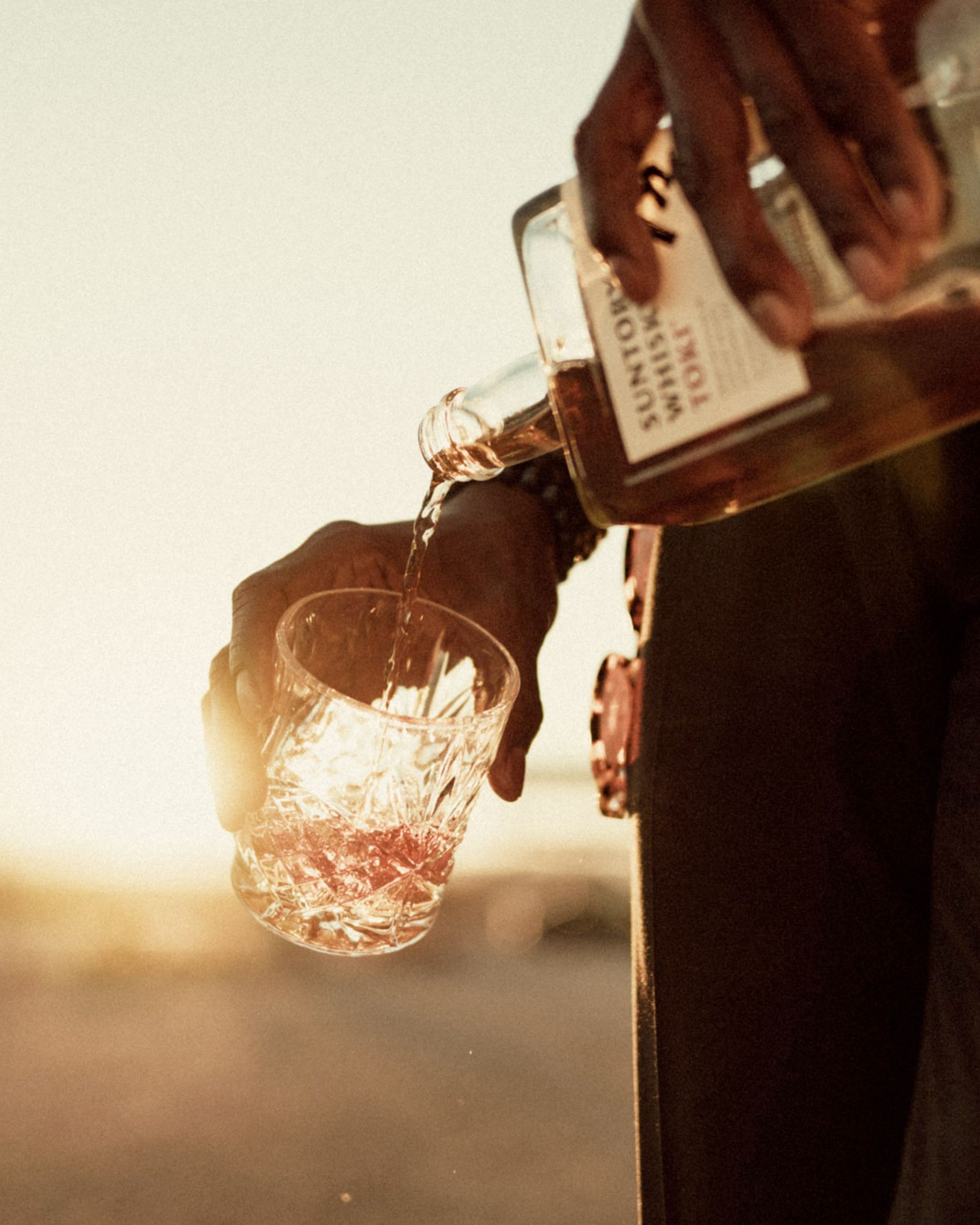 a man pouring whiskey into a glass