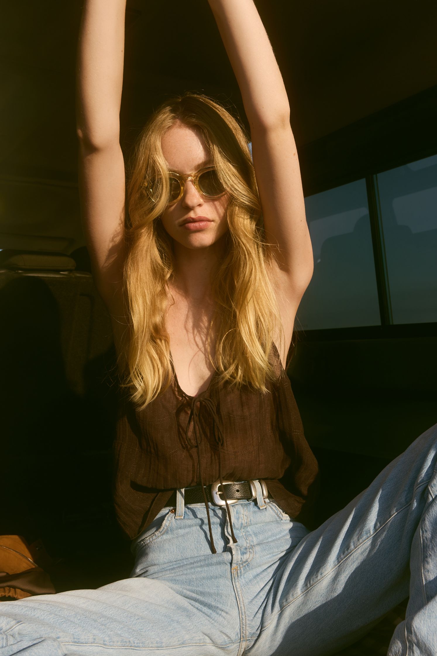a blonde woman sitting in the back seat of a car
