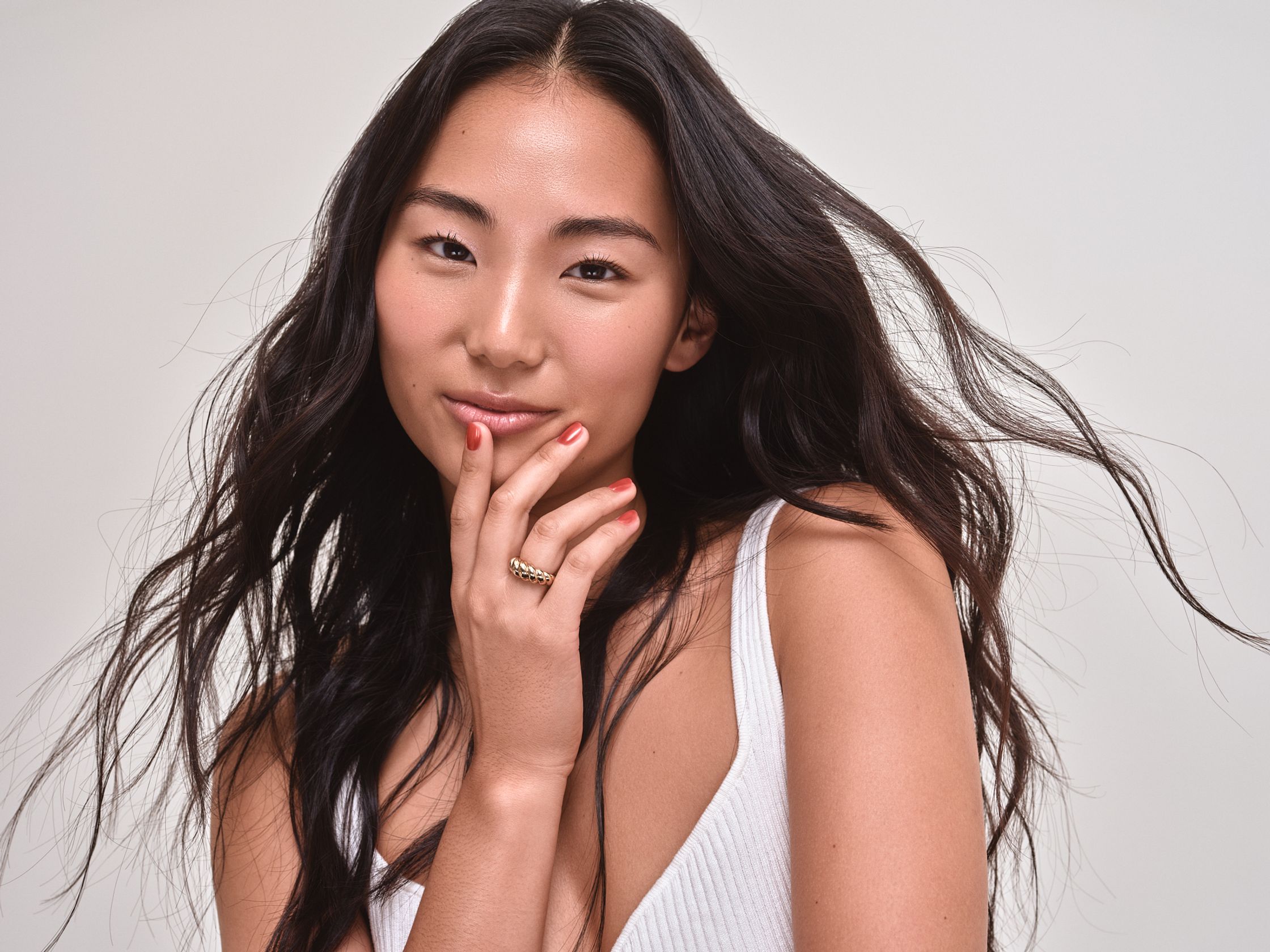 a woman with long hair posing for a photo