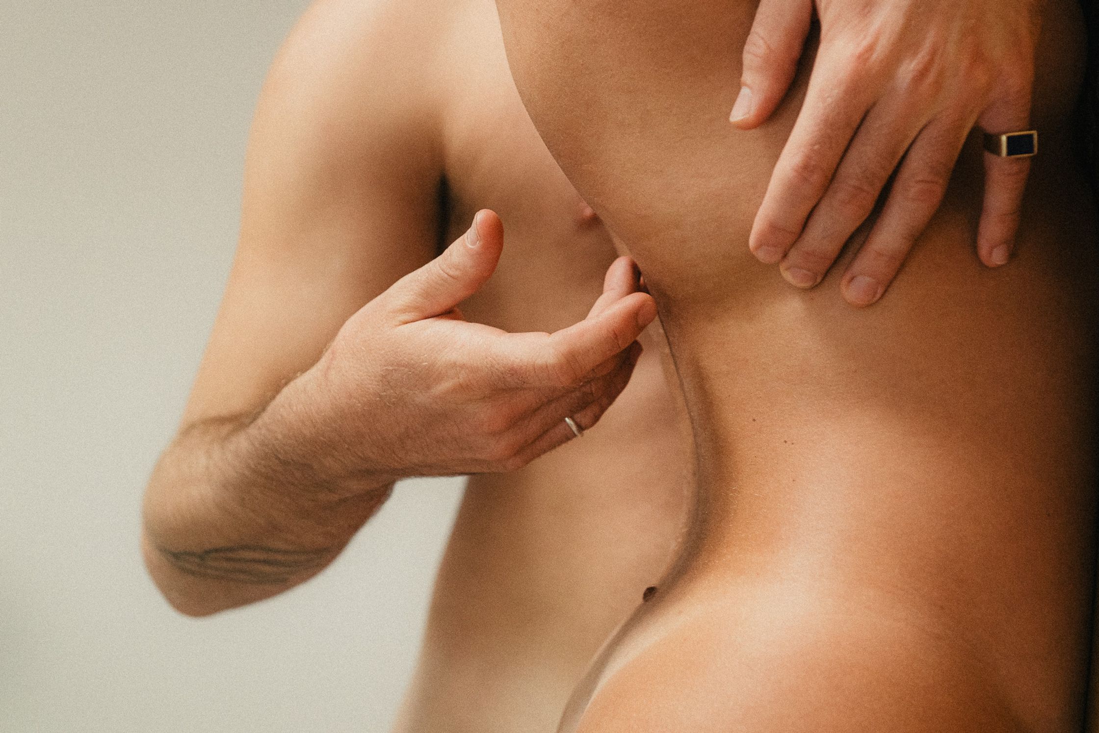 a man putting his hand on a woman's back