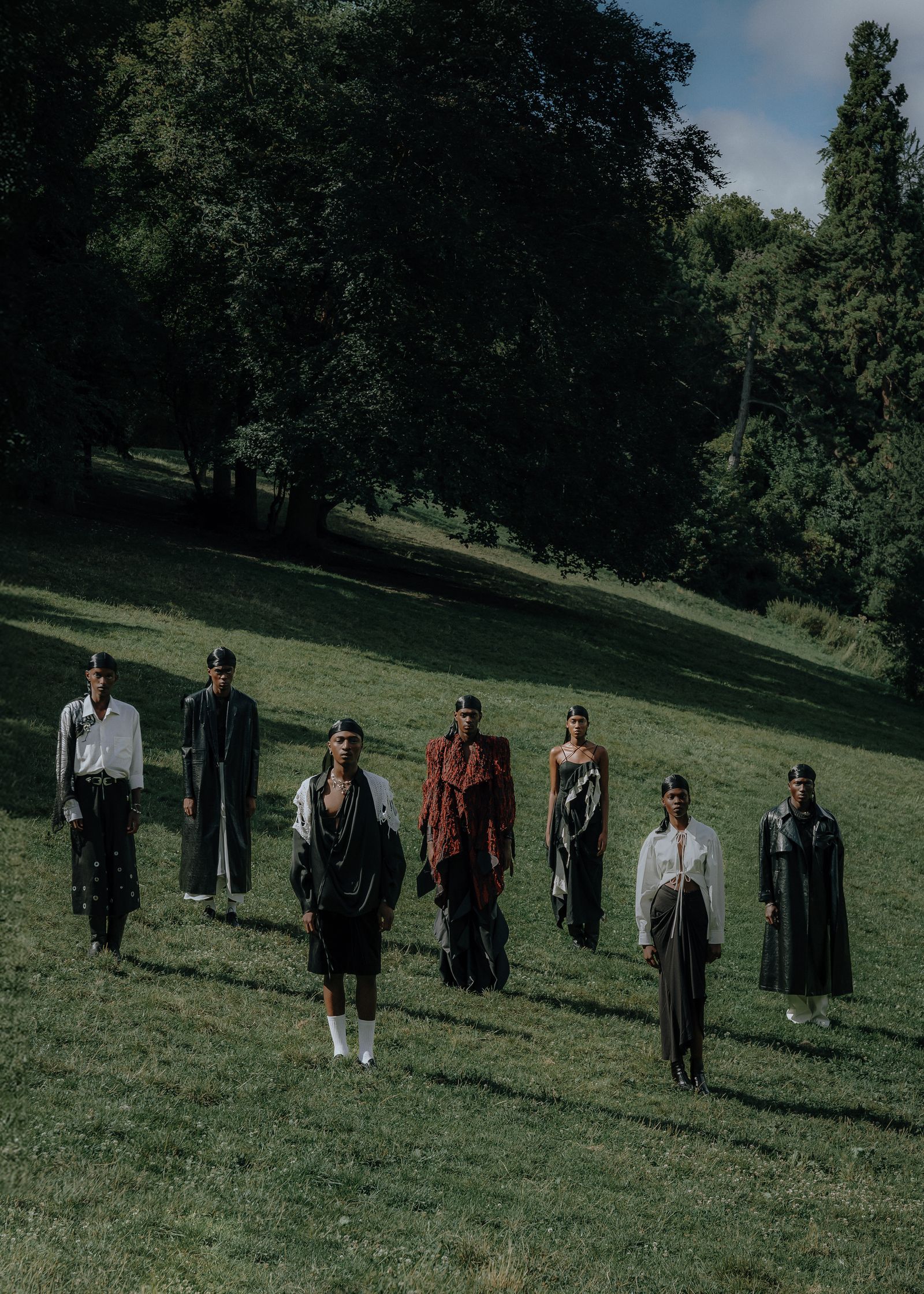 a group of people standing on a grassy field in paris