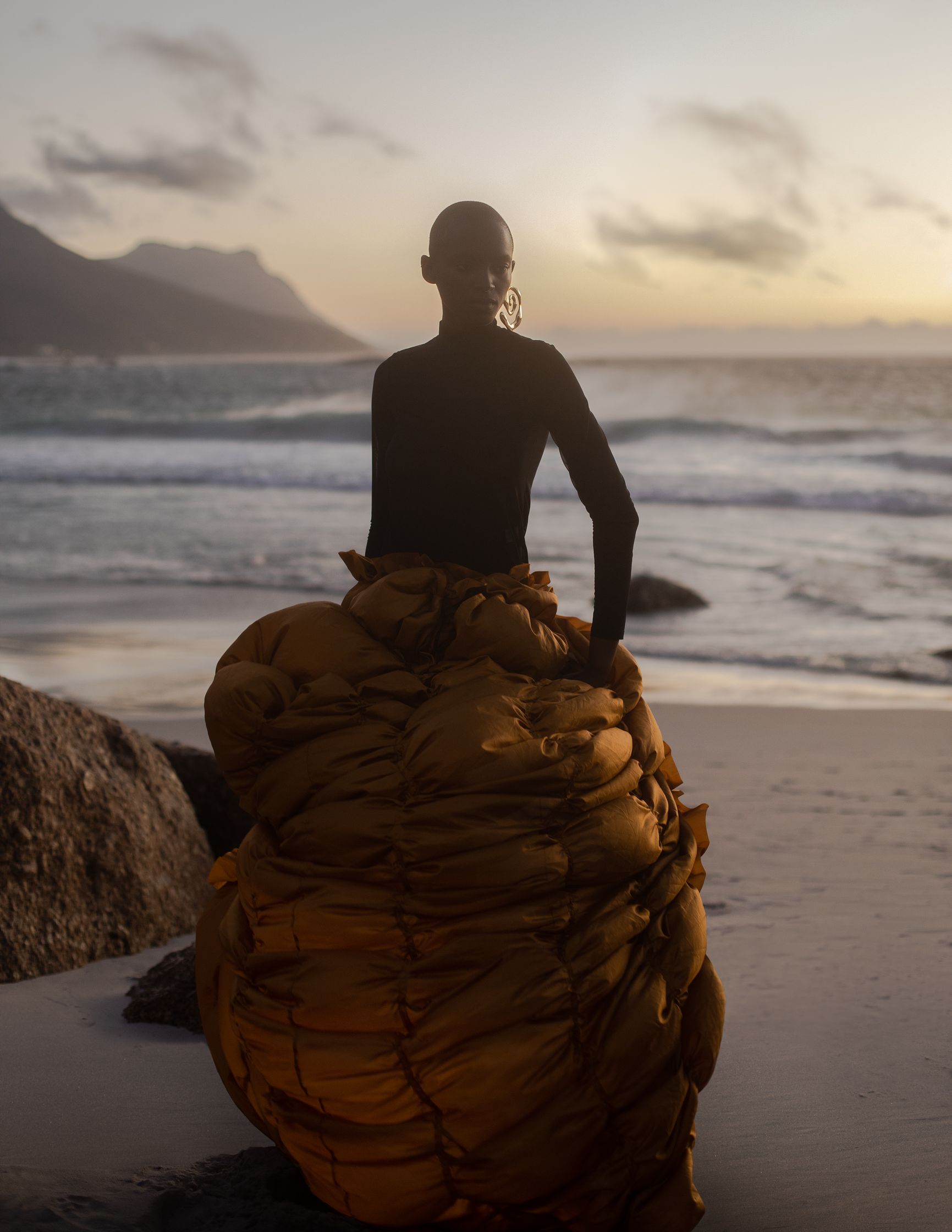 a person sitting on a blanket on the beach