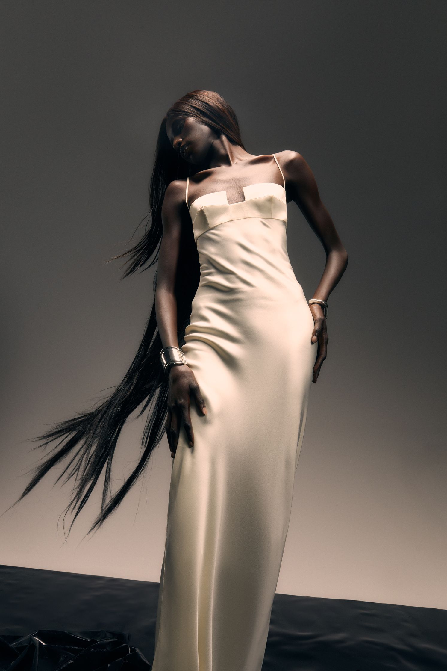a woman in a white dress with long hair