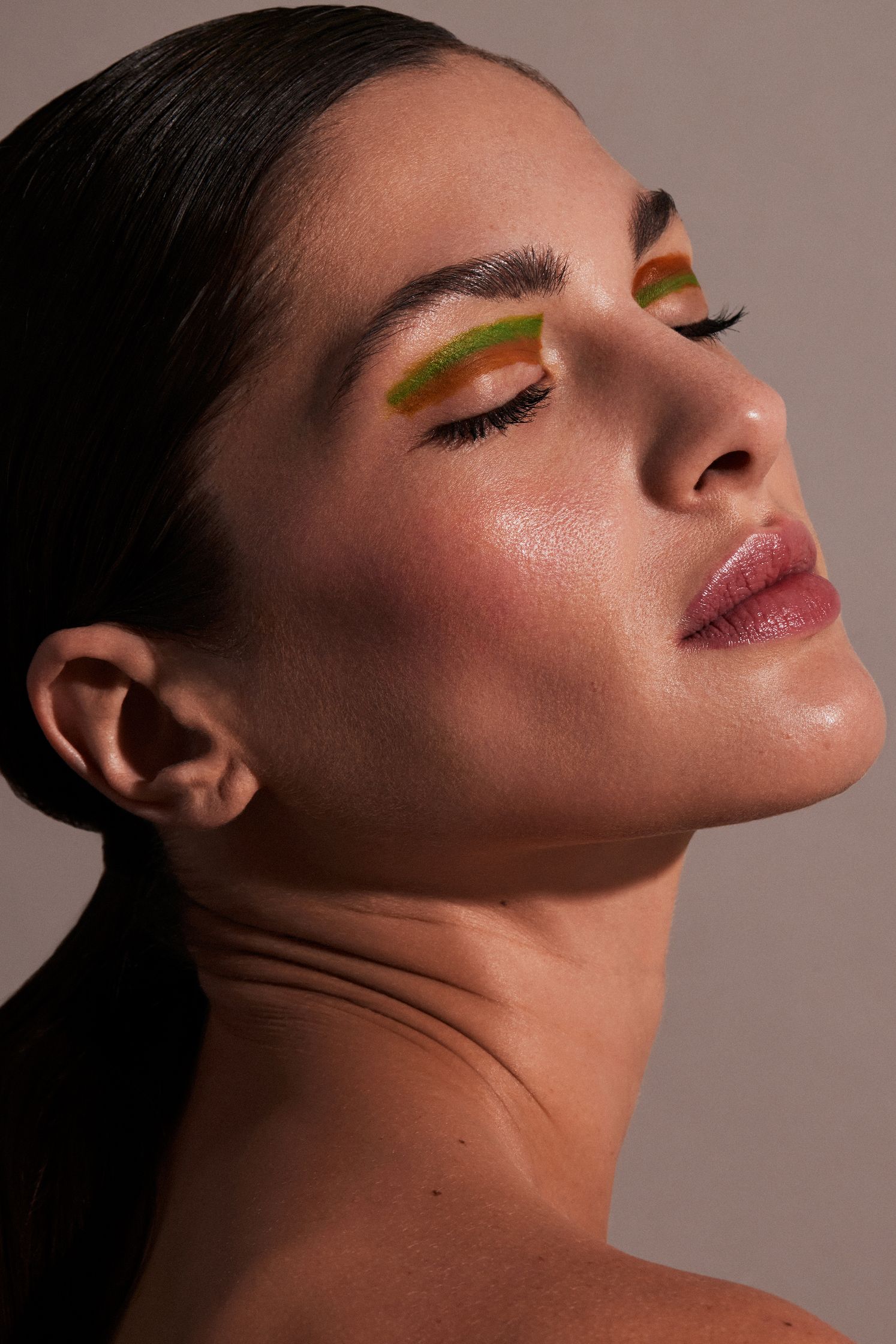 a woman with a green eyeshadow and green eyeliner