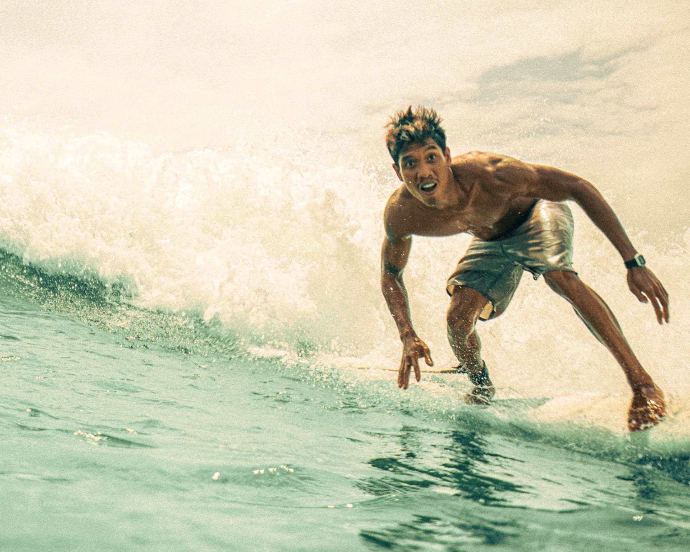 Action shot of a surfer carving a wave at Gerupuk reef, Lombok.