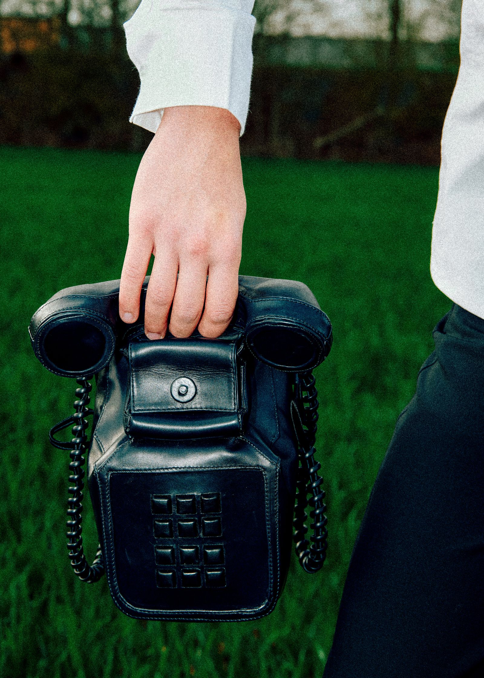 a person is holding a bag made like a phone in their hand