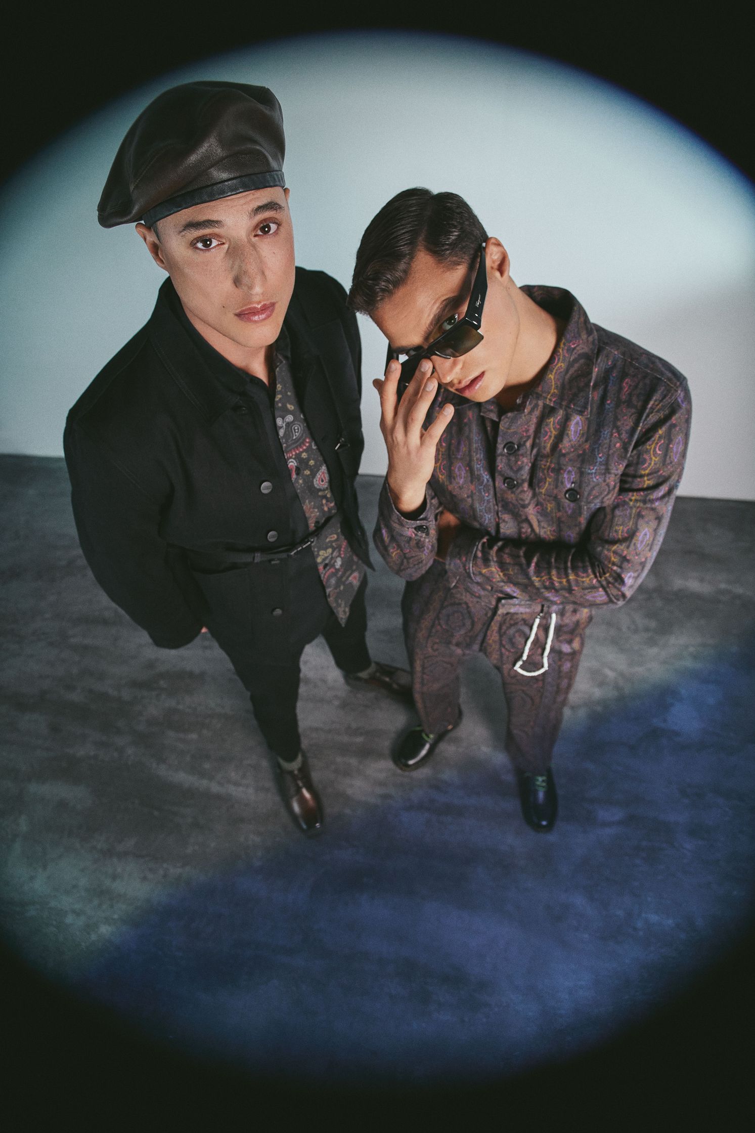 two men standing in front of a mirror