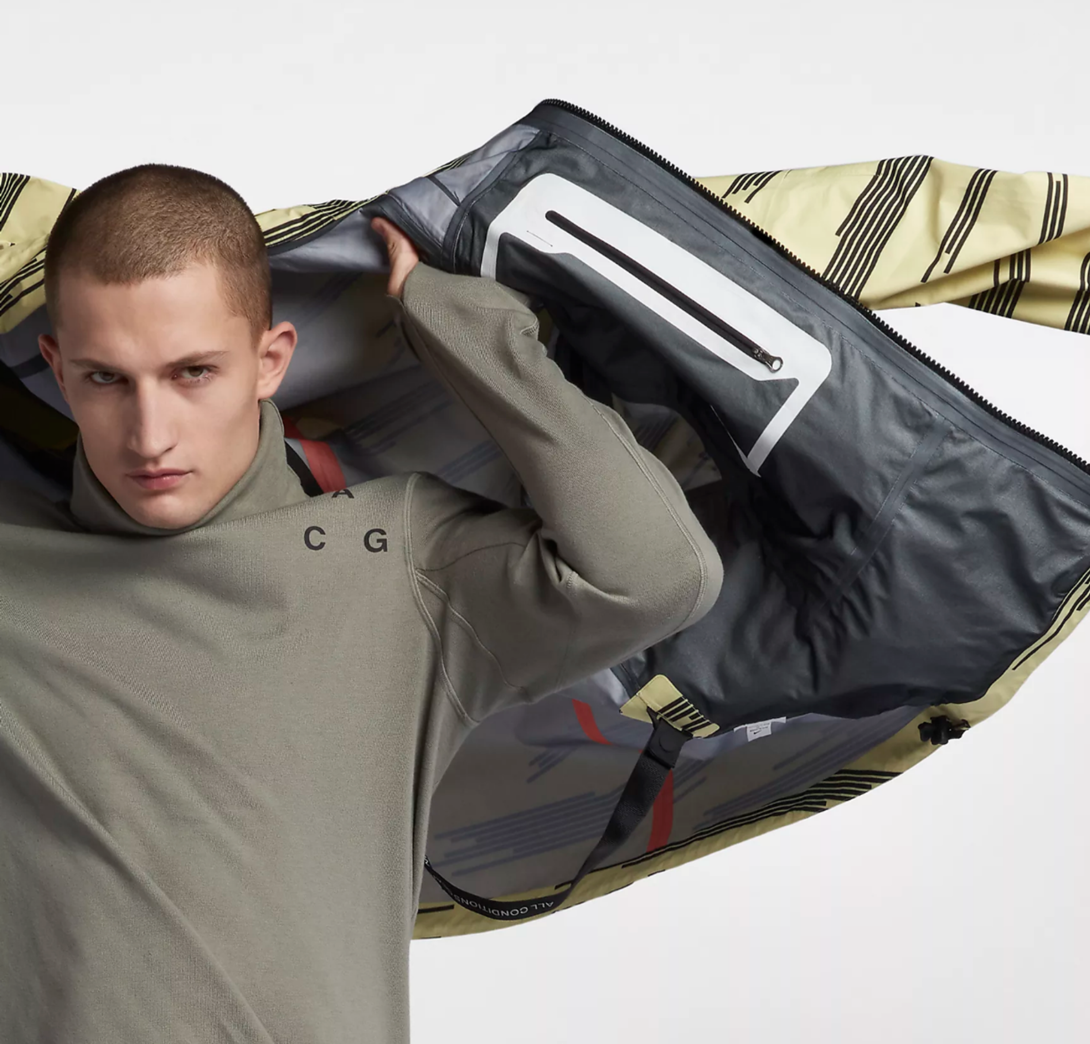 a man is holding up a bag with a nike logo on it