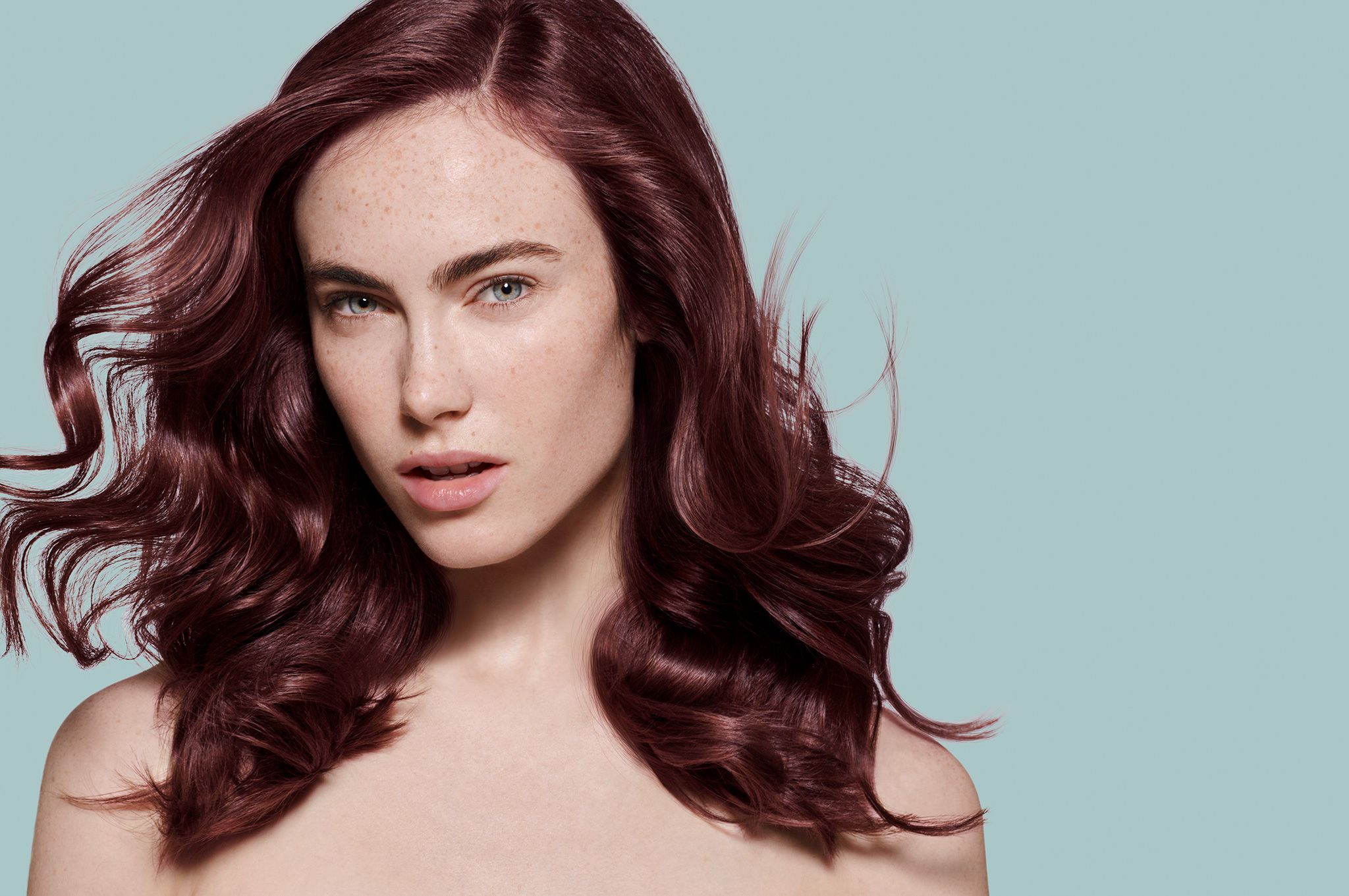 Model staged on a new background in a complementary color